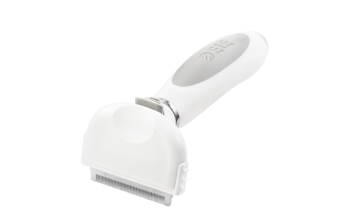 Small white deshedding brush for dogs with fine metal teeth and ergonomic handle, to reduce shedding and remove loose fur.